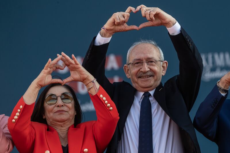 The Kilicdaroglus return the heart gesture to his supporters. Getty