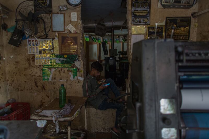 A man uses his mobile phone to work.