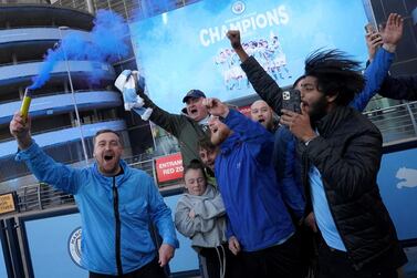 Manchester City fans celebrate outside Etihad Stadium as their team has been confirmed as Premier League champions for the third time in four seasons on May 11, 2021 in Manchester, England. Getty Images