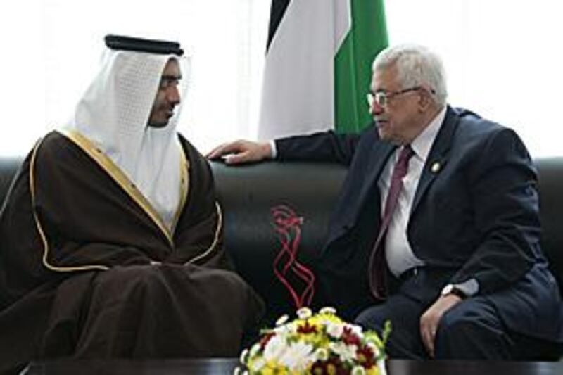 Abdullah bin Zayed, left, the foreign minister, meets with Mahmoud Abbas, the Palestinian president, at an international conference on aid for Gaza in Sharm el-Sheikh, Egypt yesterday.