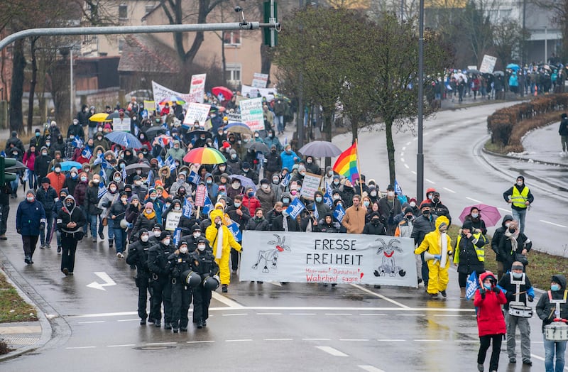 Protesters in Ansbach, Germany, march with a banner with the inscription 'Fresse Freiheit.  Mask off! Take a breath! Tell the truth!'  AP