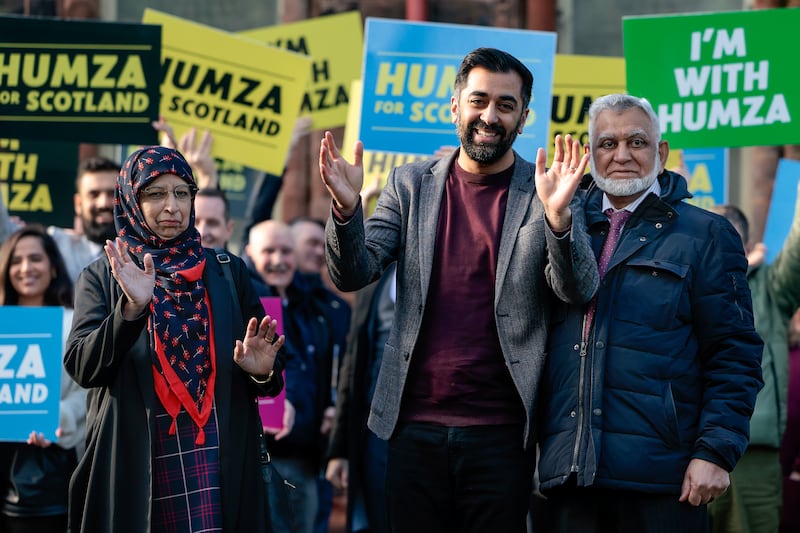Mr Yousaf stands with his mother Shaaista and father Muzaffar as he campaigns to become the next leader of the Scottish National Party in February in Glasgow. Getty Images