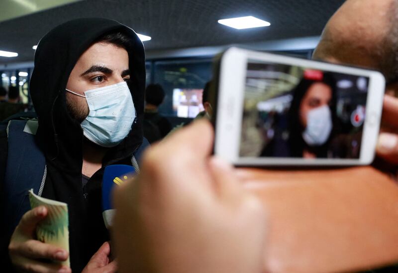 An Iraqi man speaks to the press after arriving at the airport in Baghdad. AFP