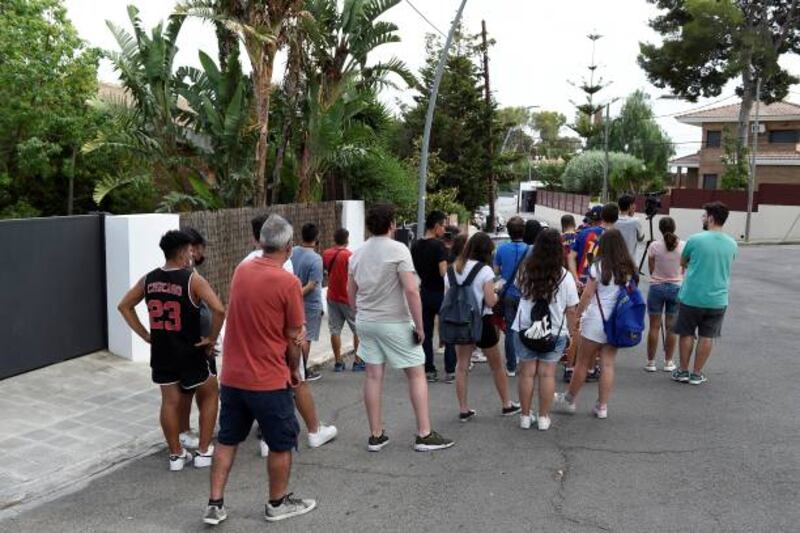 Fans gather outside the home of Barcelona's Argentinian forward Lionel Messi hoping to catch a glimpse of their hero.