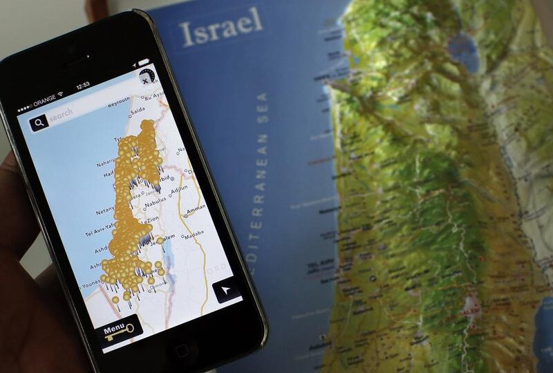 A photo taken on May 5, 2014 shows a smartphone placed on an Israeli map in Jerusalem, displaying the new Israeli NGO app called "Inakba" that allows users to find the remains of Palestinian villages that now lie inside Israel. Thomas Coex / AFP Photo

