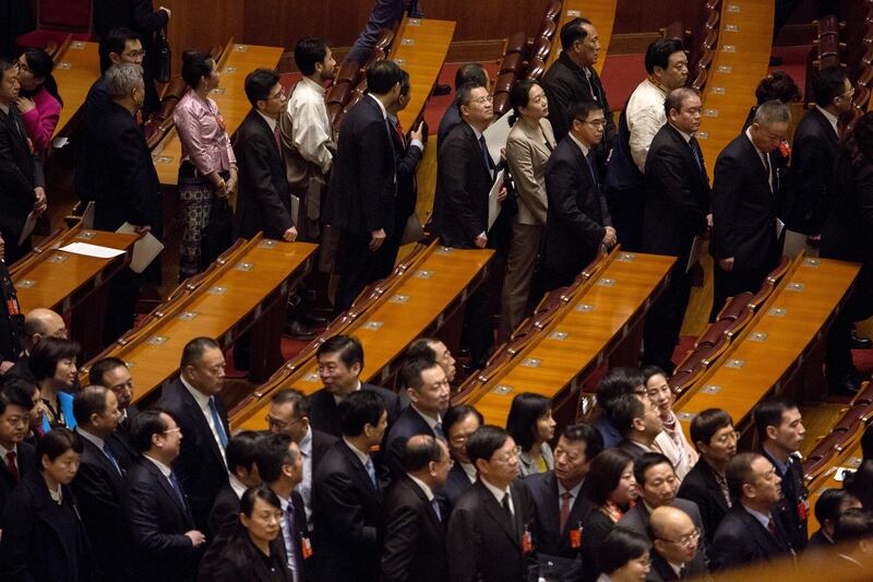Delegates leave following a vote to repeal presidential term limits at a session at the first session of the 13th National People's Congress (NPC) at the Great Hall of the People in Beijing, China, on Sunday, March 11, 2018. China's parliament voted to repeal presidential term limits, allowing President Xi Jinping to retain power indefinitely in a formal break from succession rules set up after Mao Zedong's turbulent rule. Photographer: Giulia Marchi/Bloomberg