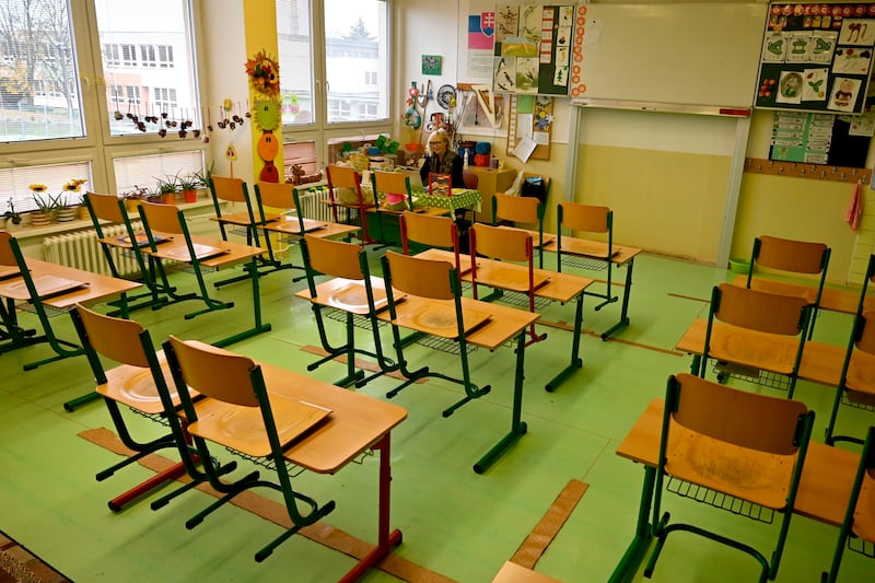 A teacher gives online lessons via webcam at the temporarily closed elementary school in the town of Trebisov, eastern Slovakia. TASR via AP