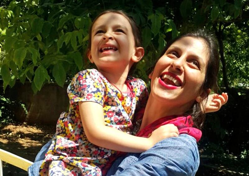 In this undated photo provided by the Free Nazanin Campaign, Nazanin Zaghari-Ratcliffe hugs her daughter Gabriella, in Iran.  Zaghari-Ratcliffe has been allowed to leave an Iranian prison for three days, her husband said Thursday, Aug. 23, 2018. Zaghari-Ratcliffe was arrested during a holiday with her toddler daughter in April 2016. Iranian authorities accuse her of plotting against the government. Her family denies this, saying says she was in Iran to visit family. (Free Nazanin Campaign/via AP)