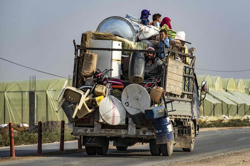 Syrians flee with their belongings.  AFP