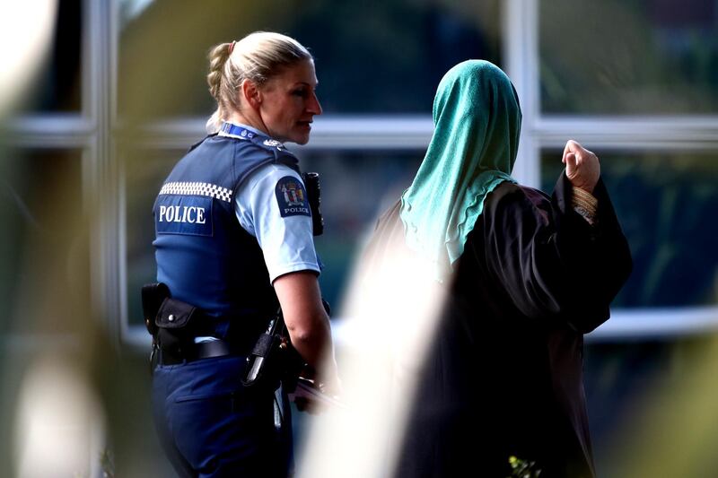 CHRISTCHURCH, NEW ZEALAND - MARCH 17: A police woman walks with a muslim woman into the community centre on March 17, 2019 in Christchurch, New Zealand. 50 people are confirmed dead, with with 36 injured still in hospital following shooting attacks on two mosques in Christchurch on Friday, 15 March. 41 of the victims were killed at Al Noor mosque on Deans Avenue and seven died at Linwood mosque. Another victim died later in Christchurch hospital. A 28-year-old Australian-born man, Brenton Tarrant, appeared in Christchurch District Court on Saturday charged with murder. The attack is the worst mass shooting in New Zealand's history. (Photo by Hannah Peters/Getty Images)