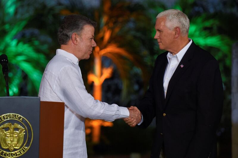 Colombia's President Juan Manuel Santos greets U.S. Vice President Mike Pence after a press conference in Cartagena, Colombia August 13, 2017. Colombian Presidency/Handout via REUTERS ATTENTION EDITORS -  THIS IMAGE HAS BEEN SUPPLIED BY A THIRD PARTY.