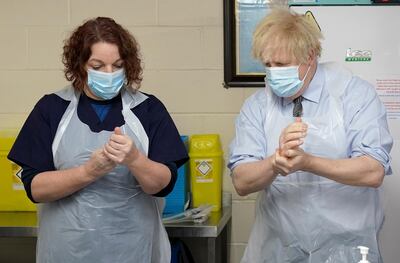 BATLEY, UNITED KINGDOM - FEBRUARY 1:  Prime Minister Boris Johnson is shown how to prepare the vaccine by advance nurse practitioner Sarah Sowden as he visits a COVID-19 vaccination centre in Batley, on February 1, 2021 in West Yorkshire, England. (Photo by Jon Super - WPA Pool/Getty Images)