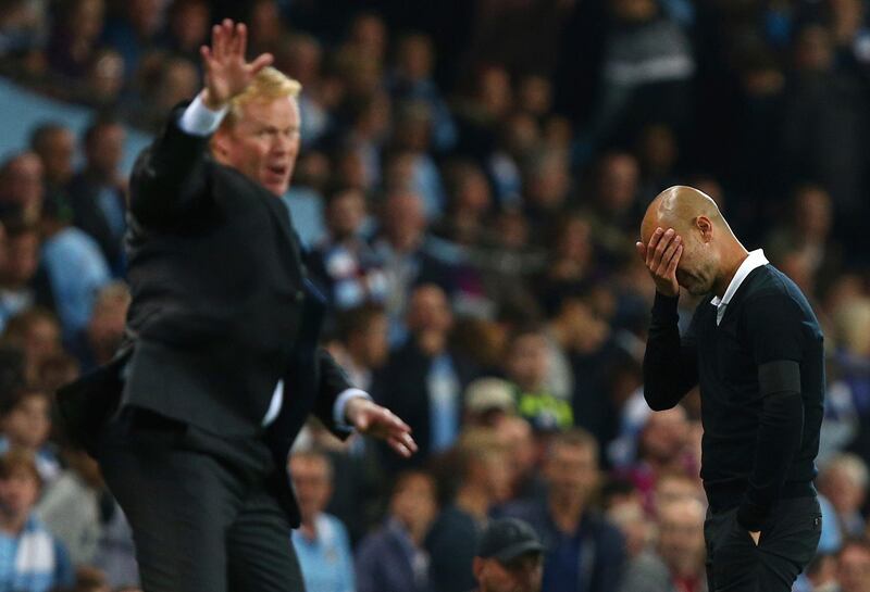 Everton manager Ronald Koeman, left, and Manchester City manager Pep Guardiola during the English Premier League soccer match between Manchester City and Everton at the Etihad Stadium in Manchester, England, Monday, Aug. 21, 2017. (AP Photo/Dave Thompson)