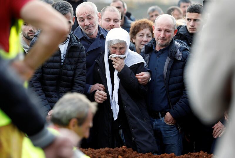 Relatives mourn during the funeral of six members of the Cara family, killed during the earthquake. Reuters
