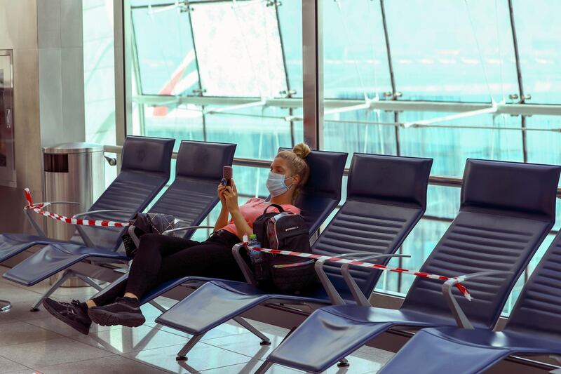 A passenger waits before boarding at Dubai International Airport on April 27, 2020. Reuters