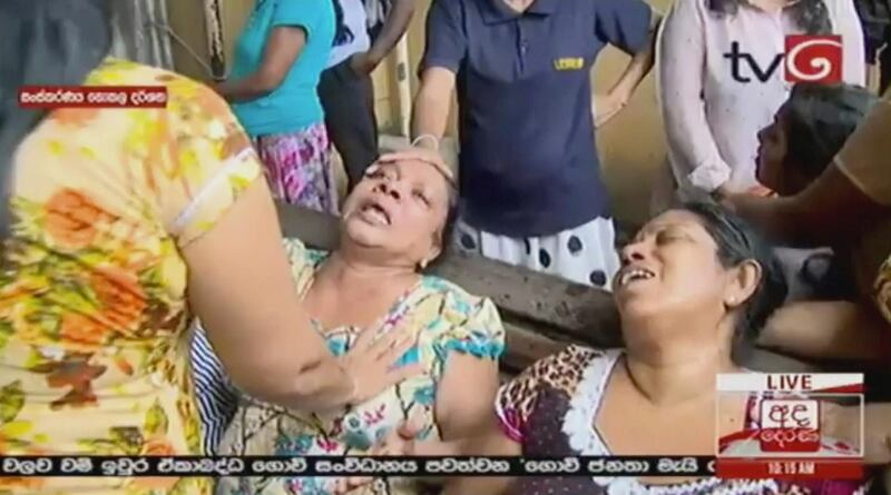 This image made from video, released by Derena TV shows women in despair after an explosion in Colombo, Sunday. Derena TV via AP