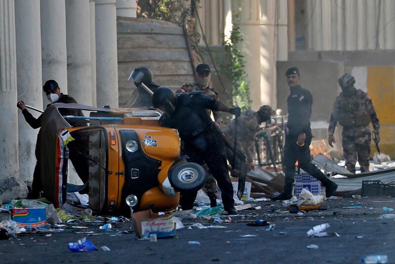 Iraqi security forces crashes a Tuk-tuk that belongs to a volunteer who helped anti-government protesters during clashes in the al-Rasheed street in Baghdad. AP Photo