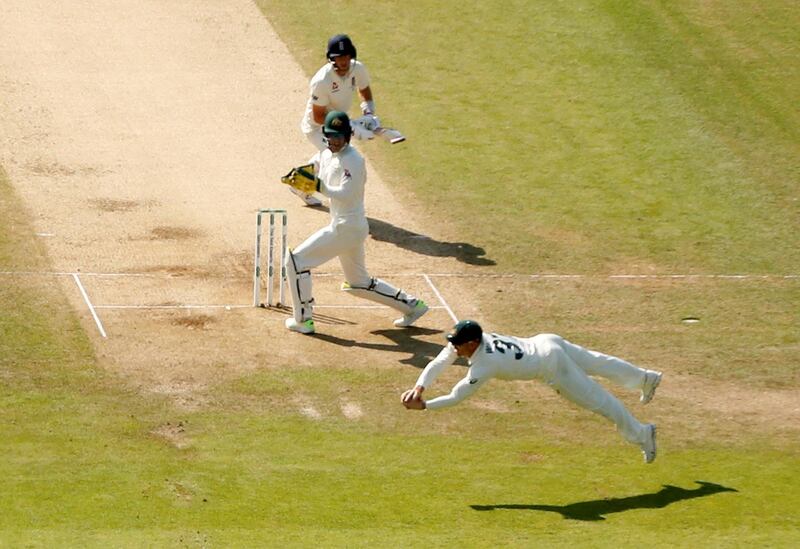 Australia's David Warner takes a catch from Nathan Lyon's bowling to dismiss England's Joe Root. Reuters