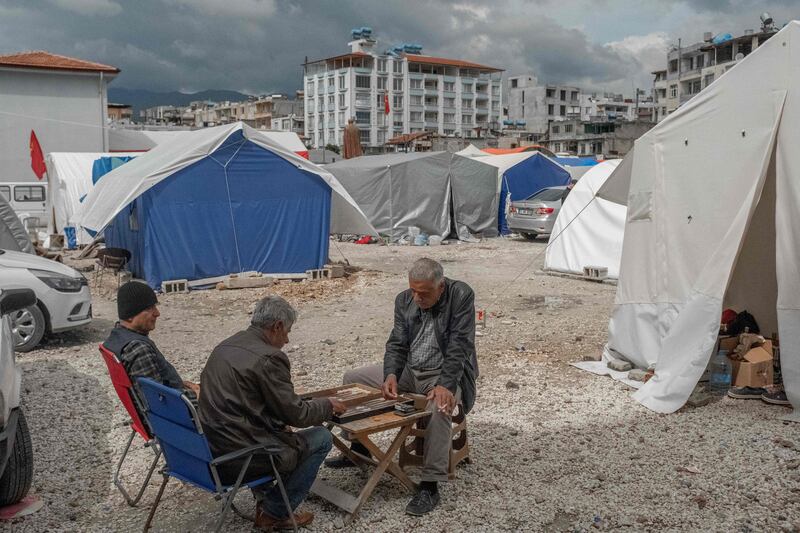 Men in the in Turkish coastal province of Hatay play backgammon on the beach weeks after an earthquake struck the region. AFP