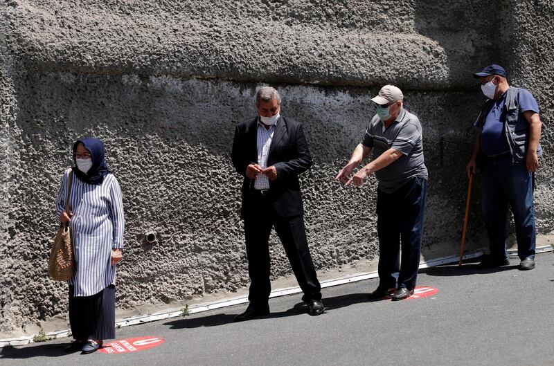 Elderly people aged 65 and above, who are not allowed to go out of their houses except six hours on Sundays, maintain social distance as they wait in line to enter at a park in Istanbul, Turkey. Reuters