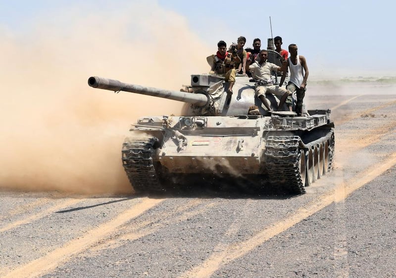 Fighters loyal to Yemeni President Abedrabbo Mansour Hadi drive a tank in the area of the strategic Bab al-Mandab Strait, in the southern Yemeni province of Taez. Saleh Al-Obeidi / AFP 