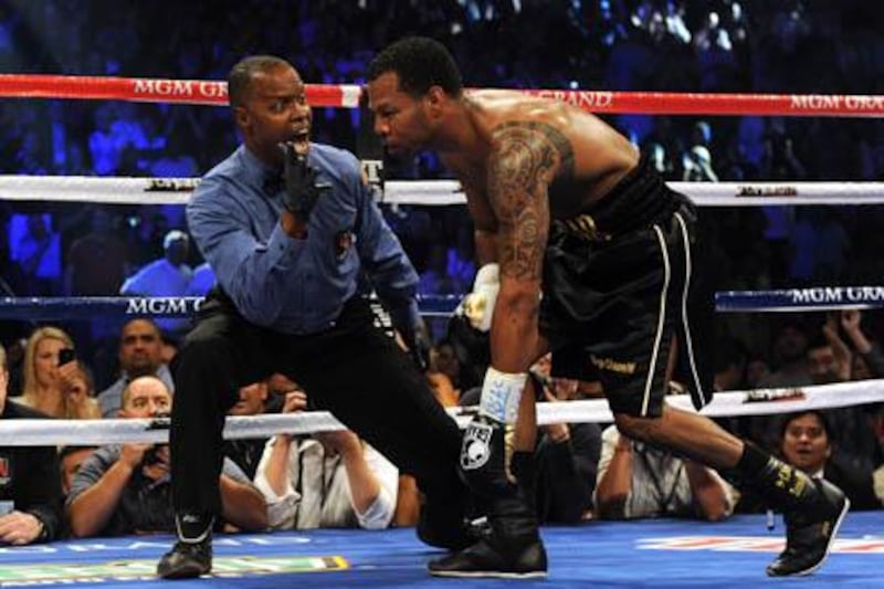 Shane Mosley of the US (R) tries to stand up after being knocked down by Manny Pacquiao of the Philippines in their bout for the World Boxing Organization (WBO) welterweight title at the Garden Arena in the MGM Grand in Las Vegas, Nevada on May 7, 2011. Pacquiao retained the WBO welterweight title by beating Mosley to extend his winning streak to 14 bouts.    AFP PHOTO / GABRIEL BOUYS

