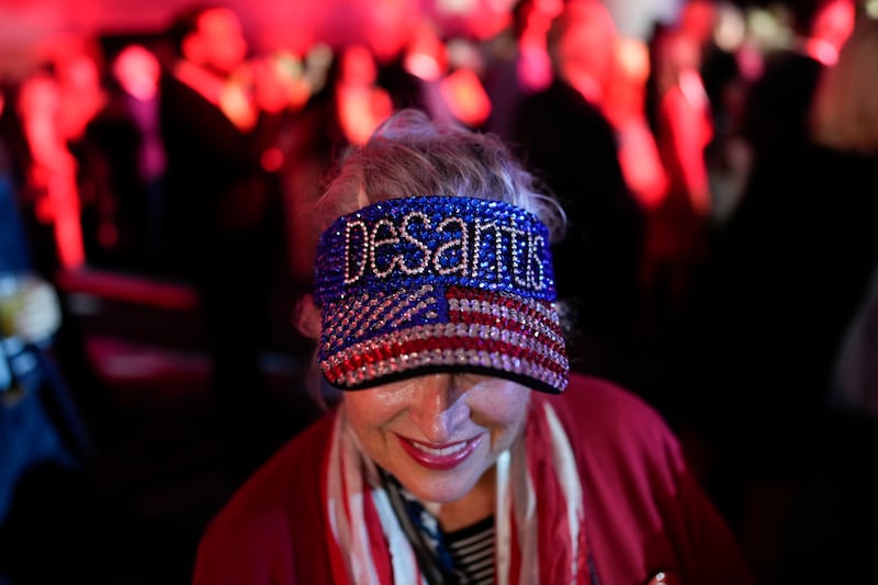 A woman arrives before Florida's Republican Governor Ron DeSantis speaks to supporters during an election night party in Tampa. AP