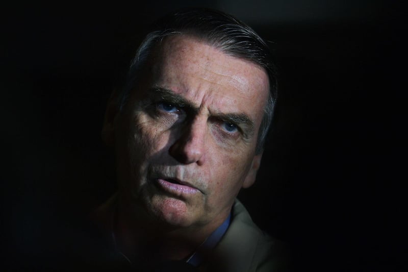 (FILES) In this file picture taken on October 17, 2018 Brazilian far-right presidential candidate Jair Bolsonaro speaks to the press during a visit to the Federal Police station in Rio de Janeiro, Brazil.  Brazilian supreme court judge Celso de Mello on April 27, 2020 ordered an investigation into accusations by ex-justice and security minister Sergio Moro that President Jair Bolsonaro sought to "interfere" with police investigations. In his decision, obtained by AFP, de Mello gave the federal police 60 days to question Moro about his explosive allegations. The findings could result in either a request for political trial against Bolsonaro or an indictment against Moro for false testimony. / AFP / Carl DE SOUZA
