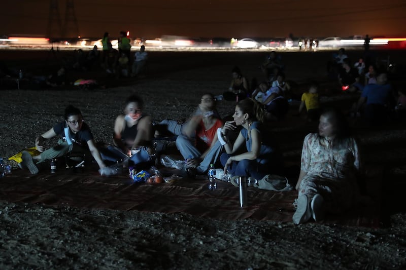 DUBAI, UNITED ARAB EMIRATES , August 13 – 2020 :- People watching the Perseid meteor shower at the Al Qudra desert area in Dubai. The event was organized by Dubai Astronomy Group with all the precaution against Covid 19 such as safe distance between the families and mask was mandatory. The event started on August 12 at 10pm to 2am on August 13.  (Pawan Singh / The National) For News/Standalone/Online/Instagram/Big Picture