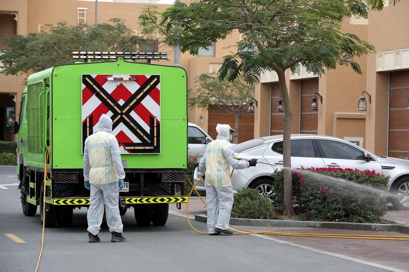 DUBAI, UNITED ARAB EMIRATES , April 11 – 2020 :- Dubai Municipality workers disinfecting the streets in Al Furjan area in Dubai. Dubai is conducting 24 hours sterilisation programme across all areas and communities in the Emirate and told residents to stay at home. UAE government told residents to wear face mask and gloves all the times outside the home whether they are showing symptoms of Covid-19 or not. (Pawan Singh/The National) For News/Online/Instagram/Standalone