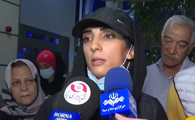 Iranian competitive climber Elnaz Rekabi, speaking to journalists upon her arrival at the airport in Tehran on October 19 after competing in South Korea without wearing a headscarf. IRIB / EPA
