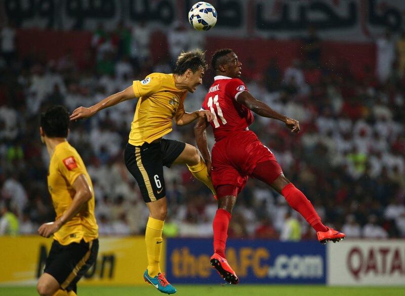 Ahmed Khalil of Al Ahli and Feng Xiaoting of Guangzhou Evergrande battle for the ball during their Asian Champions League final first leg match on Saturday in Dubai. Marwan Naamani / AFP / November 7, 2015 