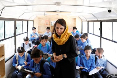 Freshta Karim, 27, founder of the mobile library bus, checks on school boys on a mobile library bus in Kabul, Afghanistan. Photo: Reuters / Mohammad Ismail