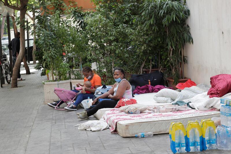 Kenyan domestic workers camp on August 20, 2020 outside the Kenyan consulate in Beirut after losing their jobs due to the economic crisis to demand repatriation back home. - An estimated 250,000 domestic workers -- mostly from Ethiopia, the Philippines and Sri Lanka -- live in Lebanon, many in conditions condemned by rights groups. Those conditions have worsened in recent months as Lebanon is grappling with its worst economic crisis in decades, as well as a coronavirus lockdown. (Photo by ANWAR AMRO / AFP)