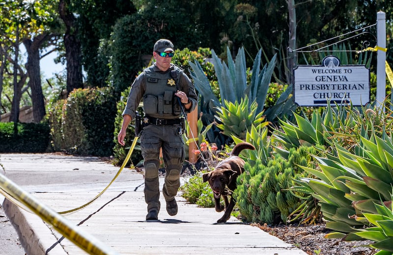 An Orange County dog unit checks the grounds outside the scene of the shooting. AP Photo