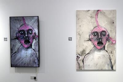 Ahmed Emad’s painting 'Time Passes Through Five Senses', right, next to its NFT counterpart, at Firetti Contemporary, Dubai. Pawan Singh / The National