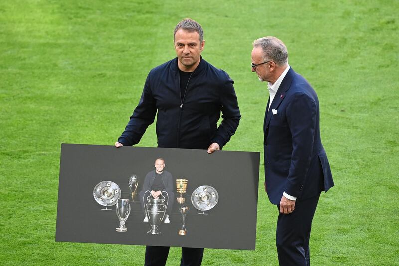 (FILES) In this file photo taken on May 22, 2021 Bayern Munich's German head coach Hans-Dieter Flick (L) poses with a poster next to Bayern Munich's CEO Karl-Heinz Rummenigge before playing his last game as for Bayern Munich's team prior the German first division Bundesliga football match Bayern Munich vs FC Augsburg in Munich, southern Germany. After 30 years managing Bayern Munich, Karl-Heinz Rummenigge is stepping down as club chairman at the end of June and replaced by former Germany captain Oliver Kahn, according to media reports on June 1, 2021. - DFL REGULATIONS PROHIBIT ANY USE OF PHOTOGRAPHS AS IMAGE SEQUENCES AND/OR QUASI-VIDEO 
 / AFP / POOL / Sven Hoppe / DFL REGULATIONS PROHIBIT ANY USE OF PHOTOGRAPHS AS IMAGE SEQUENCES AND/OR QUASI-VIDEO 
