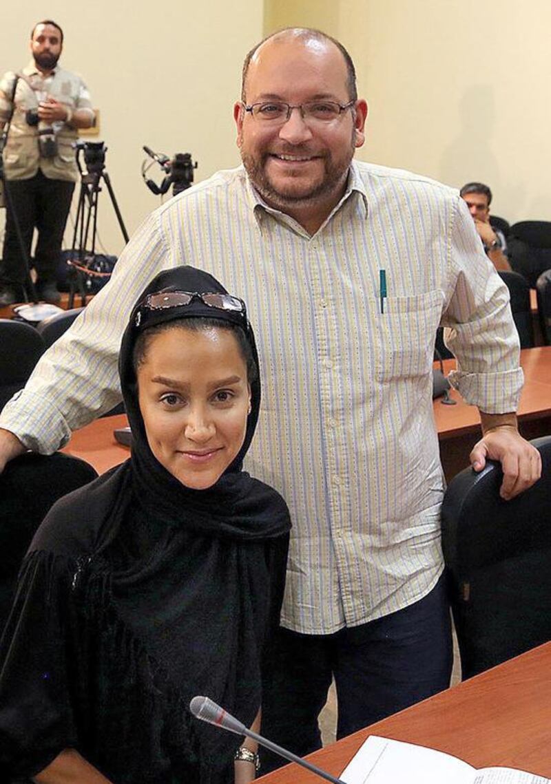 The National's reporter, Iranian Yeganeh Salehi, is pictured here with her Iranian-American husband, Washington Post correspondent Jason Rezaian, while covering a press conference at the Iranian foreign ministry in Tehran on September 10, 2013. STR/AFP Photo

