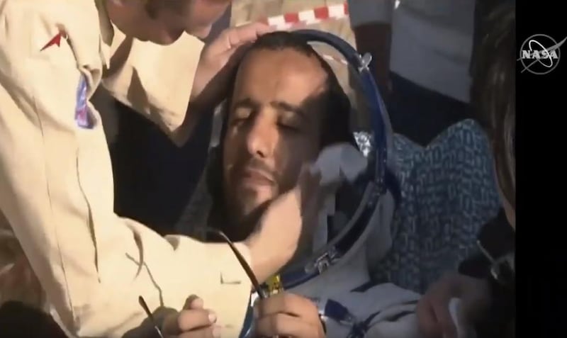 Hazza Al Mansouri is tended to by ground crews. Nasa / Youtube screengrab