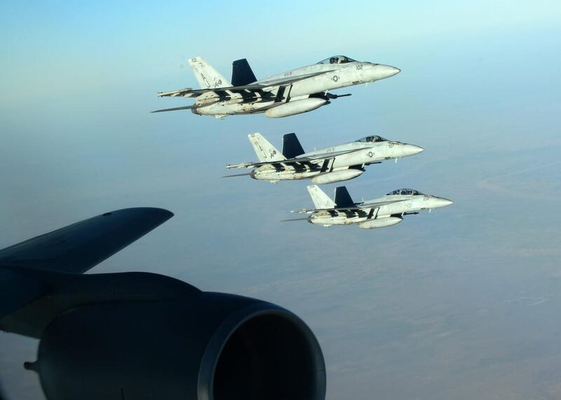 A formation of US navy F-18E Super Hornets leaves after receiving fuel from a KC-135 Stratotanker over northern Iraq as part of US-led coalition airstrikes on ISIL and other targets in Syria. Staff Sgt. Shawn Nickel / US air force / AP Photo