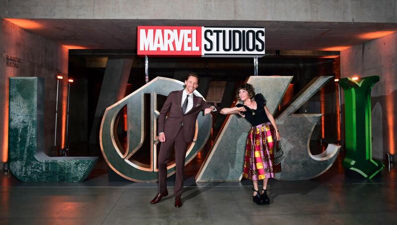 Actors Tom Hiddleston, left and Sophia Di Martino attend a photocall for Disney's Loki in London. PA via AP