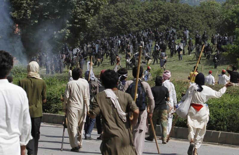 Pakistani protesters chase a troop of riot police officers during a protest near the prime minister’s home in Islamabad, Pakistan on August 31, 2014. Pakistani police clashed with scattered pockets of anti-government protesters trying to advance on the prime minister’s residence after a night of violence that saw hundreds wounded. Anjum Naveed/AP Photo