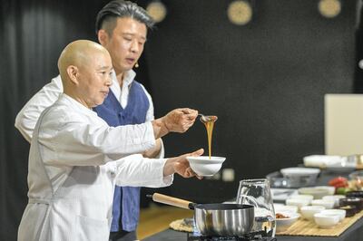 Abu Dhabi, United Arab Emirates - Jeong Kwan, a Buddhist monk and philosopher chef with interpreter Kim Jihoon at a cooking session in the Korean Cultural Centre. Khushnum Bhandari for The National