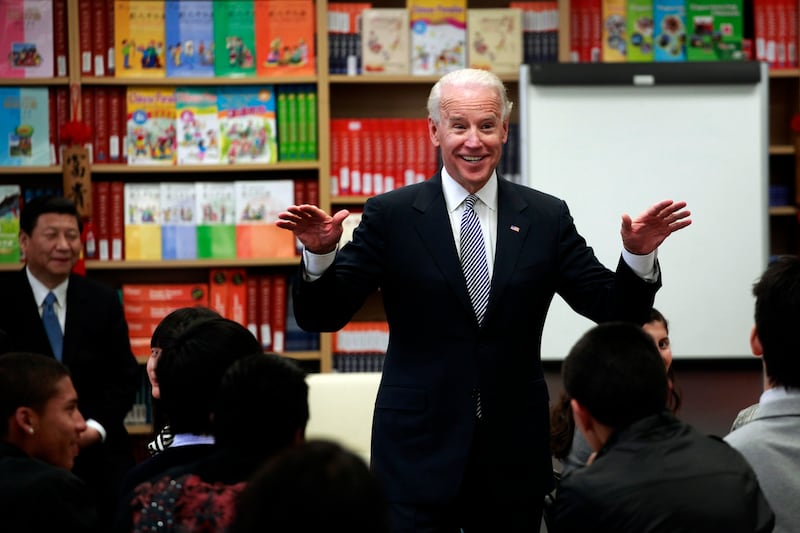 Mr Biden speaks to a Mandarin language class in South Gate, California, in February 2012, as Mr Xi listens. EPA