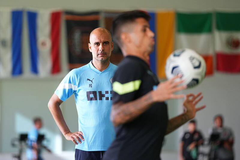 Pep Guardiola, manager of Manchester City, watches his players train.