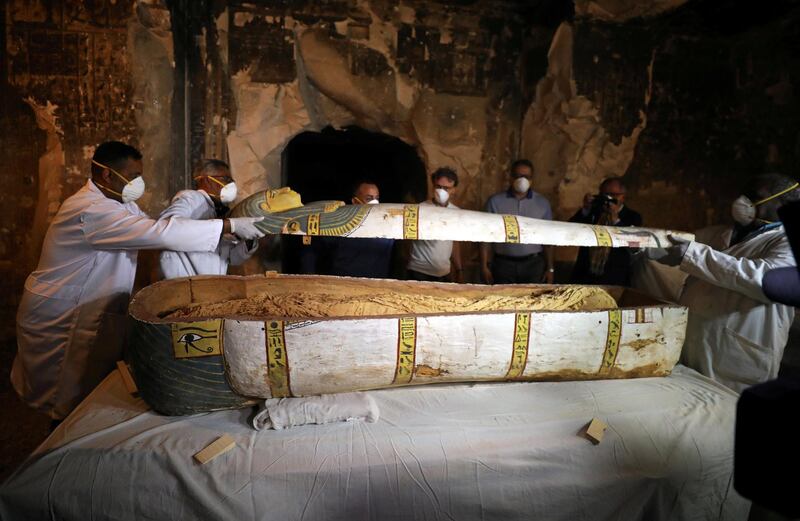 Archaeologists remove the cover of an intact sarcophagus inside the tomb TT33. Reuters