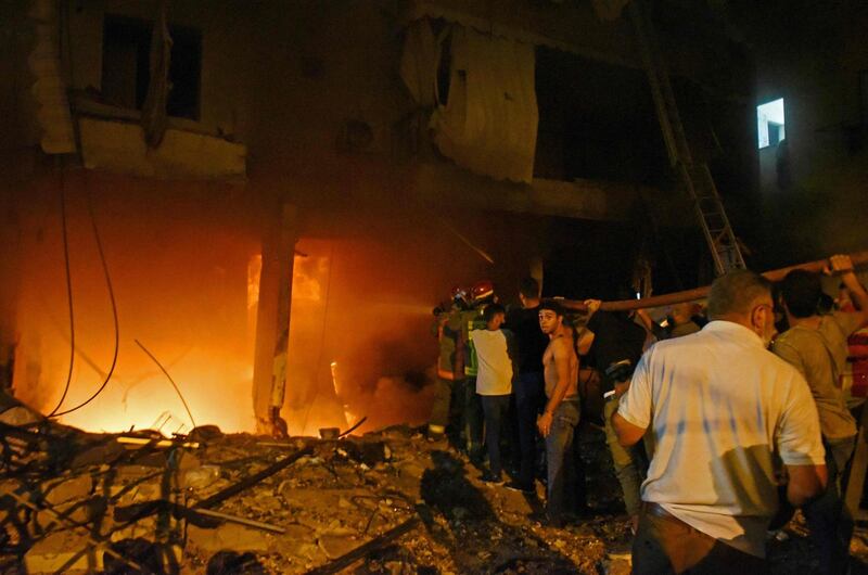 Firefighters extinguish a fire at a building after a fuel tank exploded in Beirut's Tariq al-Jdide neighbourhood.  AFP