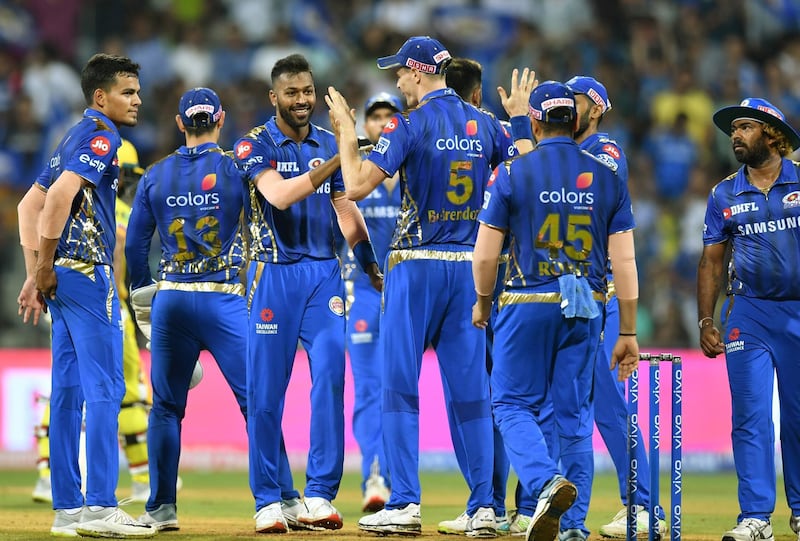 Mumbai Indians' bowler Hardik Pandya (C) celebrates with team mates after taking the wicket of Chennai Super Kings captain Mahendra Singh Dhoni during the 2019 Indian Premier League (IPL) Twenty20 cricket match between Mumbai Indians and Chennai Super Kings at the Wankhede Stadium in Mumbai on April 3, 2019. (Photo by PUNIT PARANJPE / AFP) / IMAGE RESTRICTED TO EDITORIAL USE - STRICTLY NO COMMERCIAL USE
