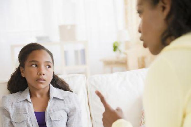 Mother lecturing daughter in living room