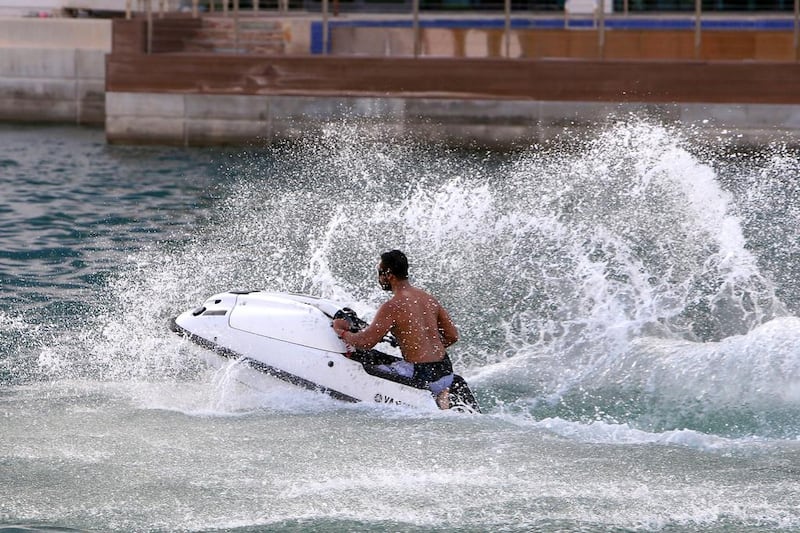 Jet ski operators are continuing to offer the motors for hire despite rules banning the practice in certain areas of Abu Dhabi. Pawan Singh / The National 